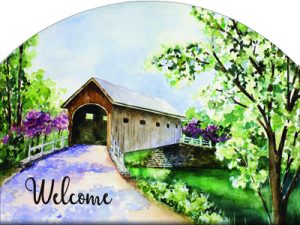 The Backyard Naturalist has outdoor garden plaques back in stock! After slate became impossible to source, the artists now put their designs on durable aluminum, protected with a UV-resistant clear coat. Designs vary, but this welcomes you with a splendid covered bridge in Spring.